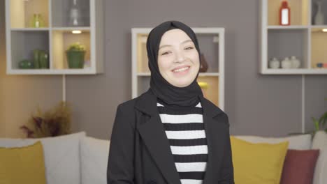 Muslimisches-Teenagermädchen-Winkt-Und-Lächelt-Und-Blickt-In-Die-Kamera.